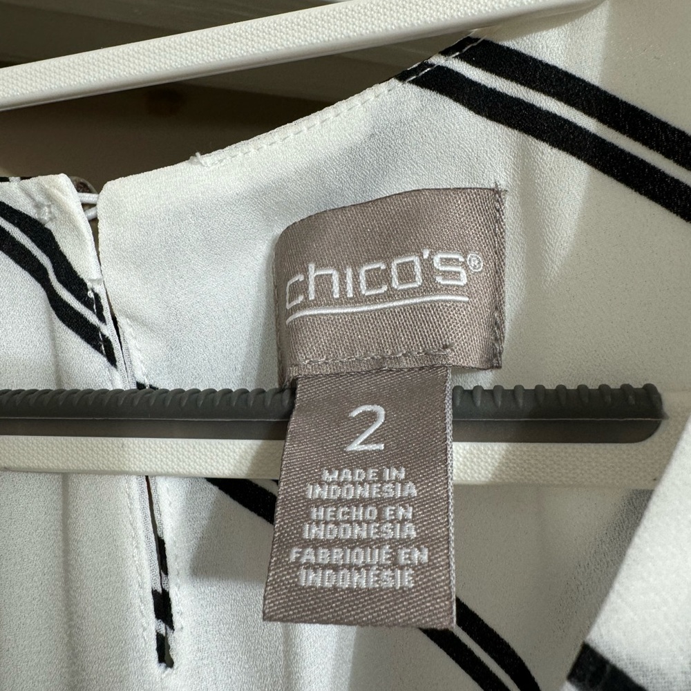 Beautiful black and white blouse, fits like a large. No stretch.